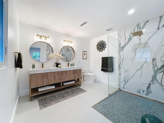 bathroom with a marble finish shower, visible vents, and toilet