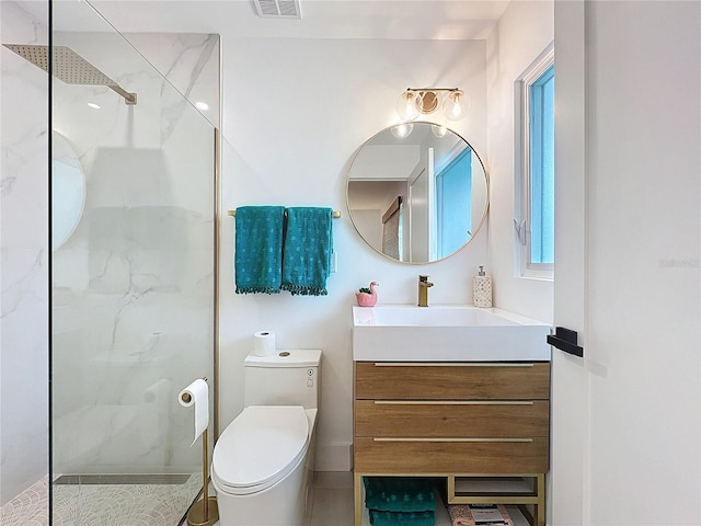 bathroom with vanity, toilet, and a walk in shower