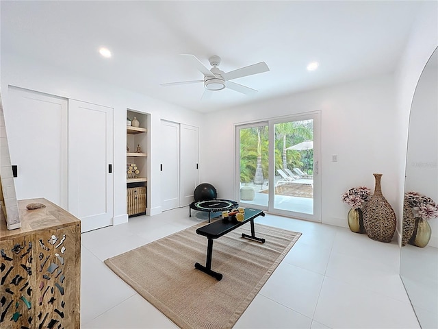 exercise room featuring built in features, recessed lighting, and ceiling fan