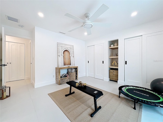 exercise area featuring baseboards, visible vents, built in features, and recessed lighting