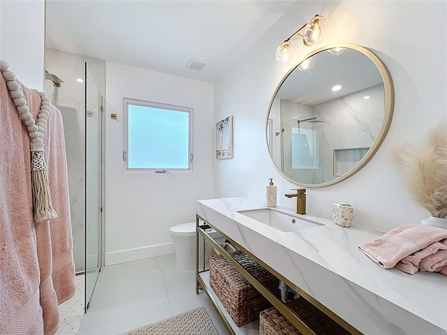 bathroom featuring toilet, vanity, visible vents, tile patterned floors, and a stall shower