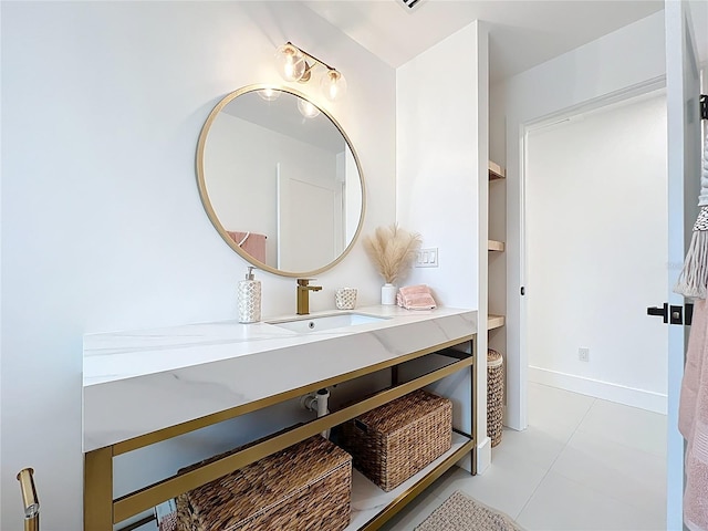 bathroom with vanity, baseboards, and tile patterned floors