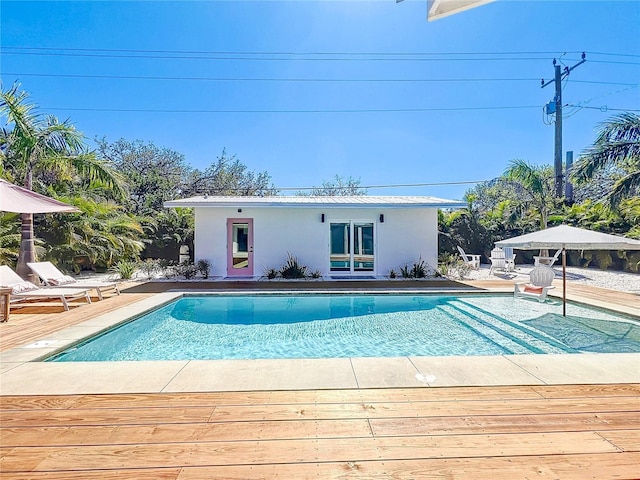 pool with a patio area and an outdoor structure