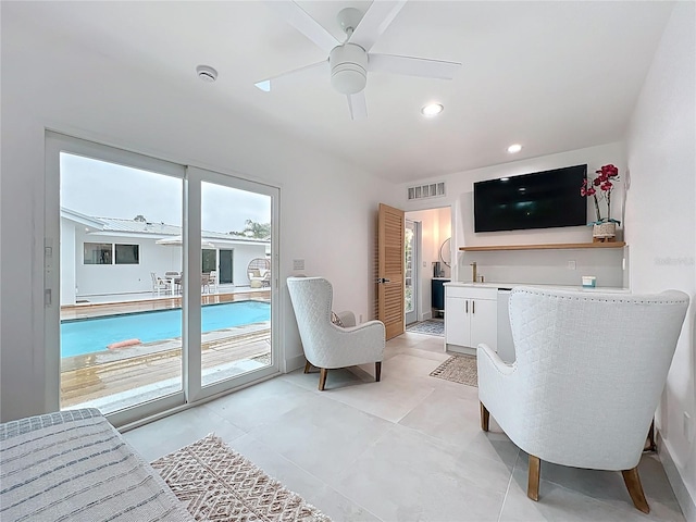 living room featuring light tile patterned floors, ceiling fan, visible vents, and recessed lighting