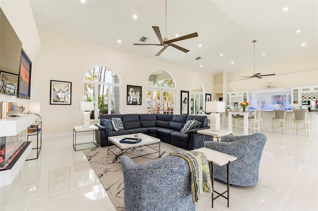 living area with recessed lighting, high vaulted ceiling, and a ceiling fan