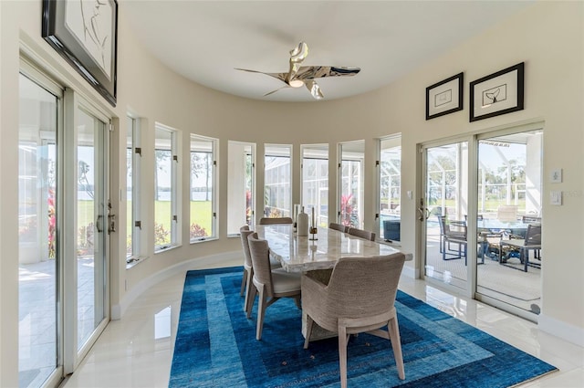 dining room featuring a wealth of natural light, baseboards, and ceiling fan