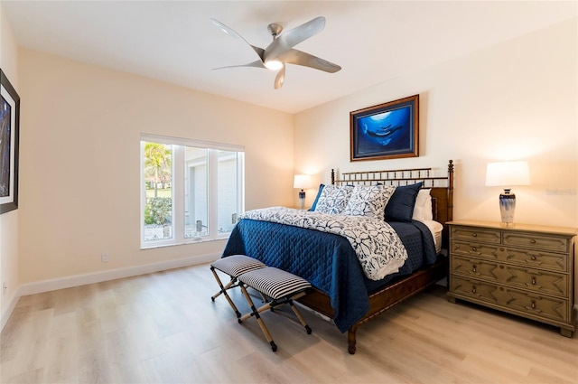 bedroom with light wood-style flooring, baseboards, and ceiling fan