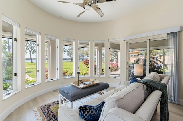 sunroom / solarium featuring a ceiling fan