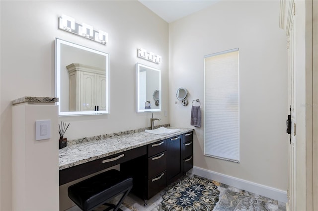 bathroom featuring vanity and baseboards