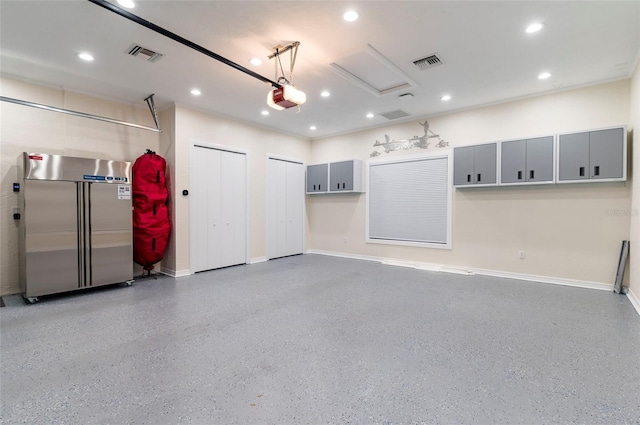 garage featuring visible vents, recessed lighting, and high quality fridge