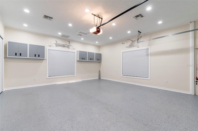 garage with recessed lighting, a garage door opener, and visible vents