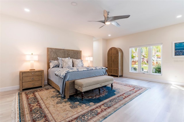 bedroom with light wood finished floors, recessed lighting, baseboards, and ceiling fan