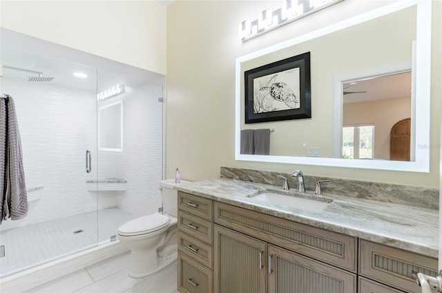 bathroom with visible vents, toilet, a stall shower, tile patterned flooring, and vanity