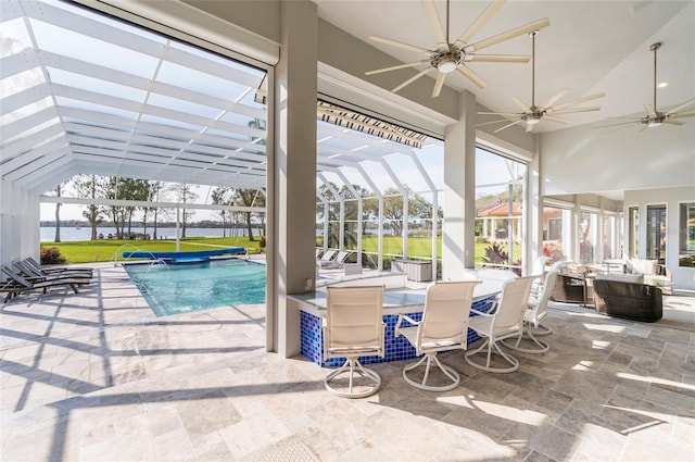 pool featuring ceiling fan, a patio, outdoor dining area, and a lanai