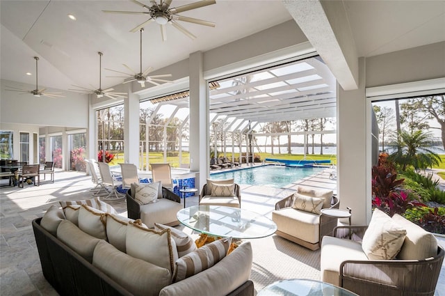 view of patio / terrace with an outdoor pool, glass enclosure, and outdoor lounge area