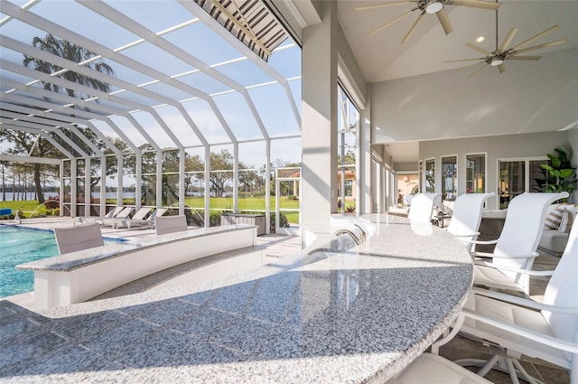 outdoor pool featuring ceiling fan, a lanai, and a patio area