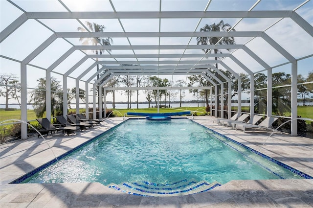 pool with glass enclosure and a patio area