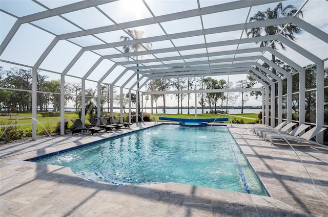 outdoor pool featuring a lanai, a lawn, and a patio