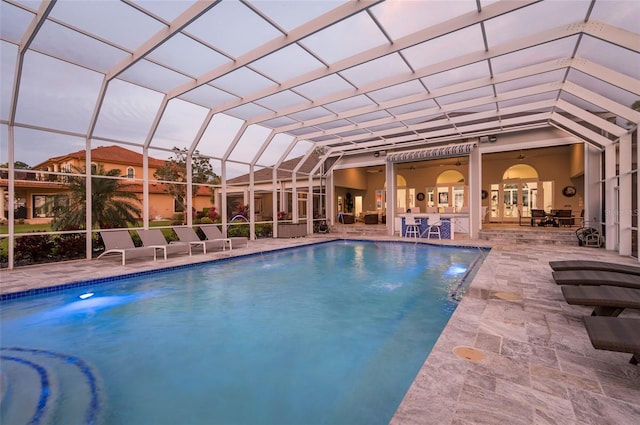 outdoor pool with a lanai and a patio area