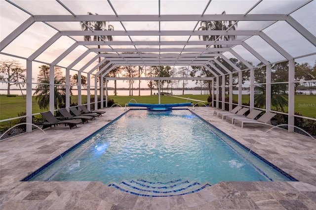 pool featuring glass enclosure and a patio area