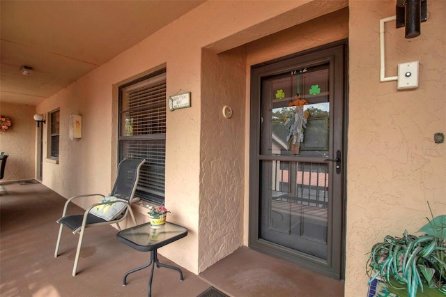 view of exterior entry with stucco siding