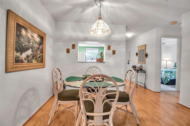 dining room featuring light wood-style flooring and a ceiling fan