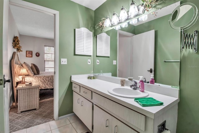 bathroom featuring baseboards, vanity, and tile patterned flooring