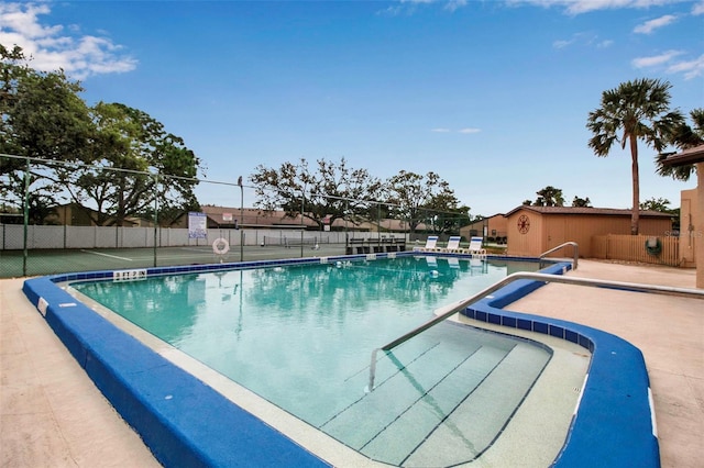 pool featuring a patio and fence