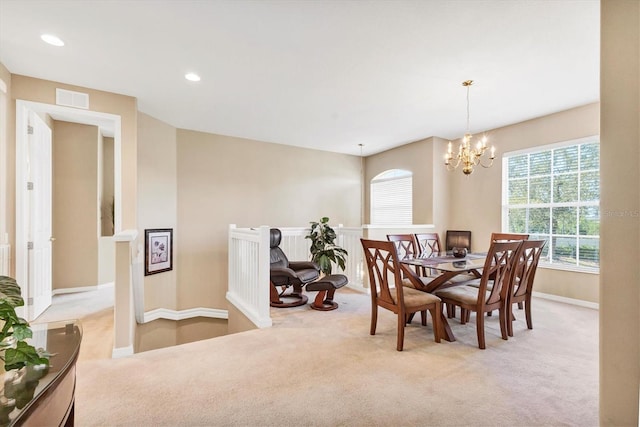 carpeted dining space with a notable chandelier, visible vents, recessed lighting, and baseboards