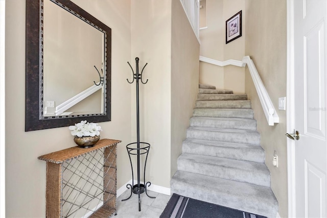 stairs featuring tile patterned flooring and baseboards