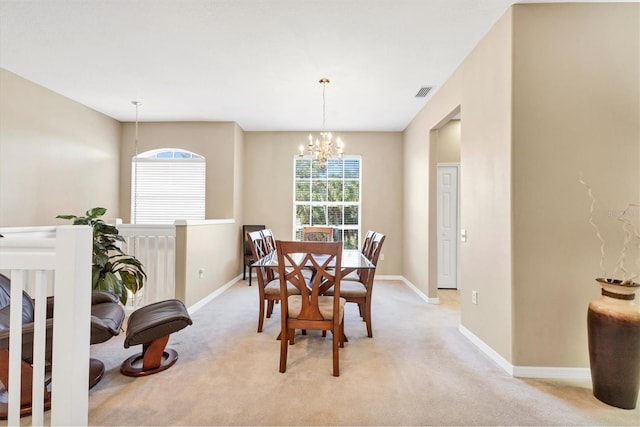 dining area featuring a wealth of natural light, visible vents, light carpet, and an inviting chandelier