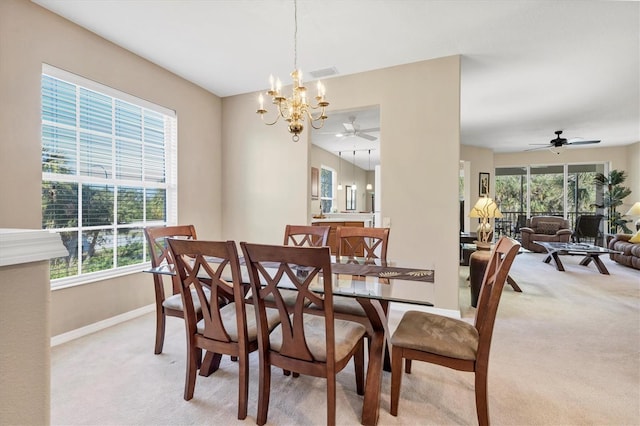 dining room with visible vents, light colored carpet, plenty of natural light, and baseboards