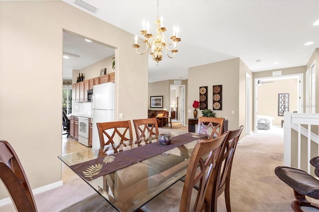 dining area with visible vents, light colored carpet, ceiling fan with notable chandelier, and baseboards