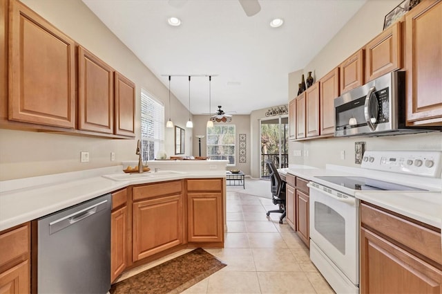 kitchen with ceiling fan, light tile patterned flooring, plenty of natural light, stainless steel appliances, and a sink