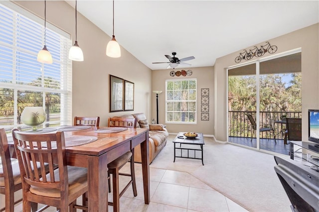 dining space with light tile patterned floors, a ceiling fan, and light carpet