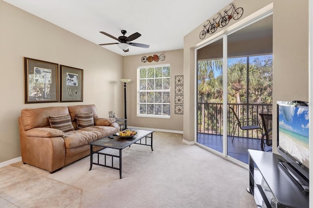 living area featuring baseboards, carpet floors, and a ceiling fan