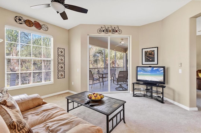 living room featuring baseboards, carpet floors, and ceiling fan