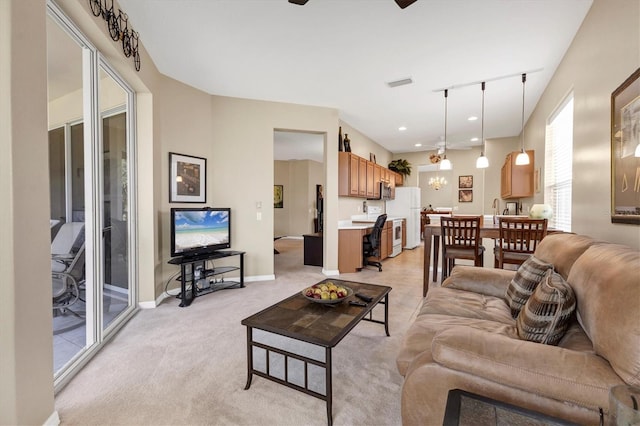 living room featuring baseboards, visible vents, recessed lighting, ceiling fan, and light carpet