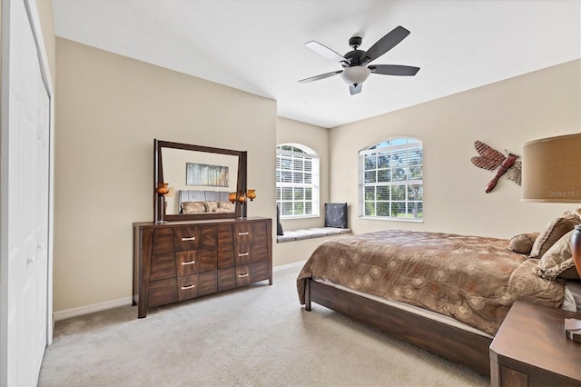 carpeted bedroom featuring baseboards, a ceiling fan, and vaulted ceiling