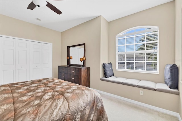 bedroom featuring ceiling fan, carpet, a closet, and baseboards