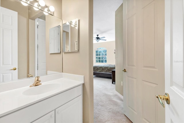 bathroom featuring connected bathroom, vanity, and a ceiling fan