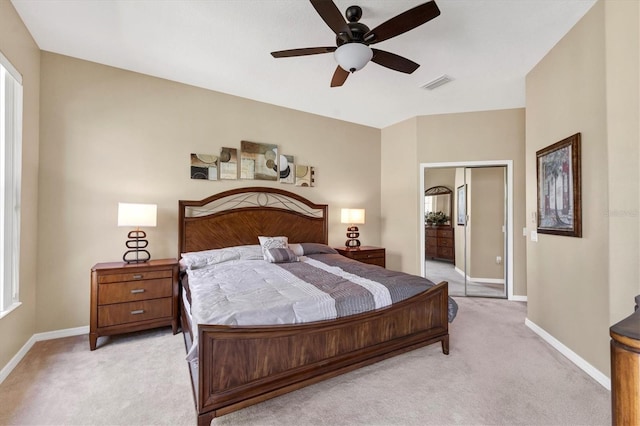 bedroom with a ceiling fan, light colored carpet, visible vents, and baseboards