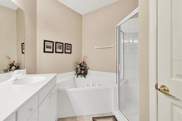 full bathroom featuring vanity, a bath, and a shower stall