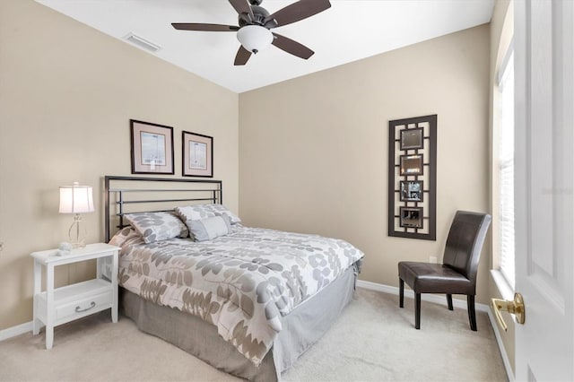 bedroom with visible vents, multiple windows, light colored carpet, and baseboards