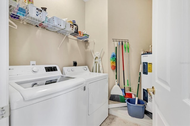 laundry room featuring laundry area, separate washer and dryer, and water heater