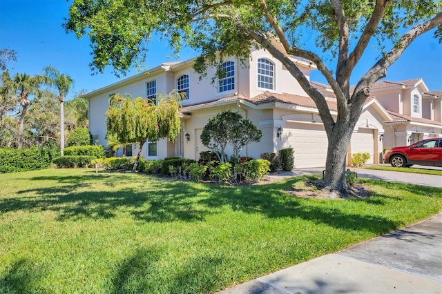 view of front facade with a tiled roof, concrete driveway, a front yard, stucco siding, and a garage