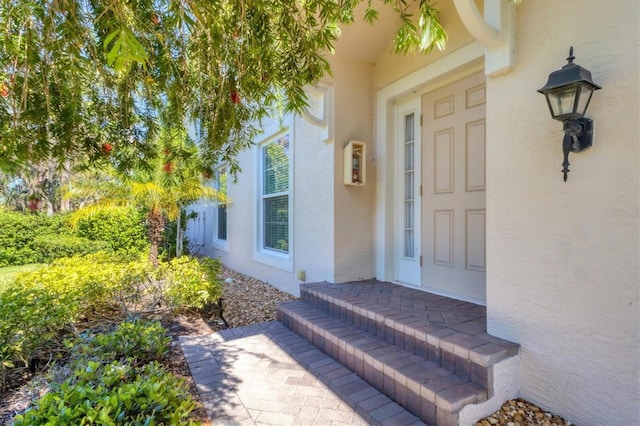 entrance to property with stucco siding