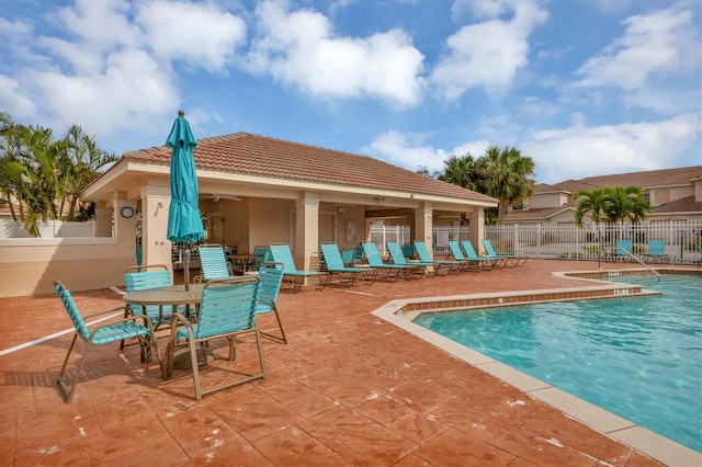 pool with a patio and fence