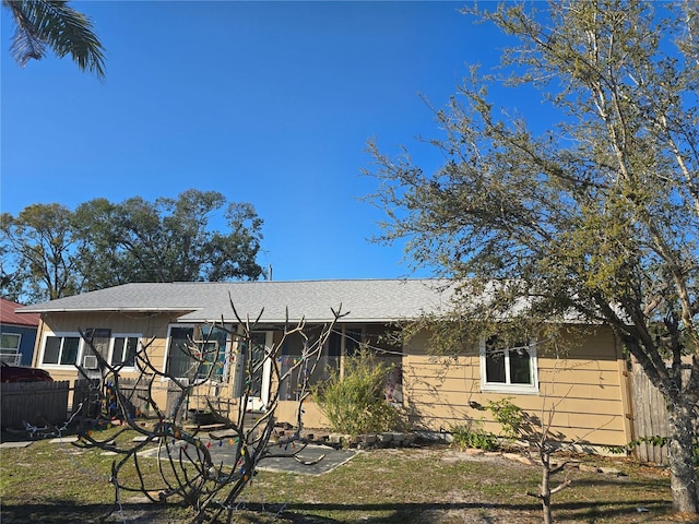 ranch-style house with fence, a front lawn, and a playground