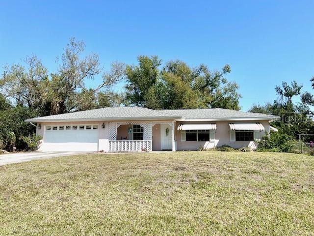 single story home featuring a front lawn, an attached garage, and stucco siding